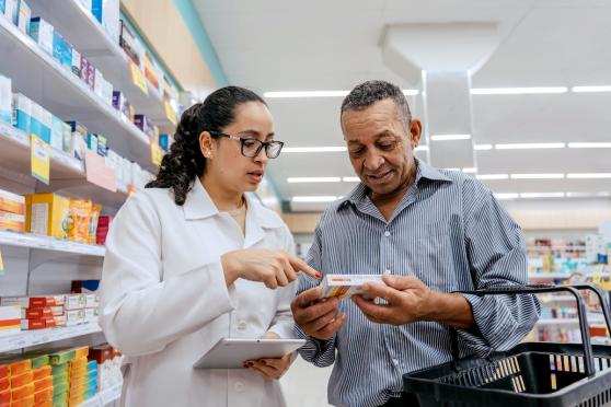 Pharmacist helping male shopper